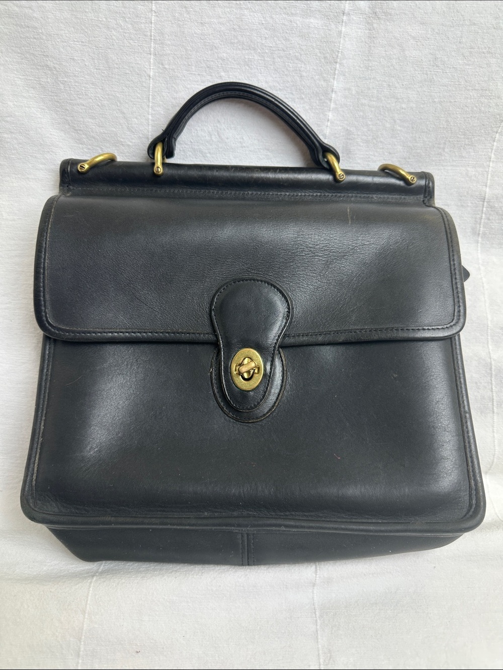 Coach Black Leather Turn-Lock Top-Handle bag with shoulder strap